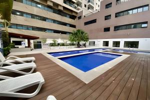 a swimming pool in the middle of a building at SHB - The Jewel Pitangueiras with complete leisure in Guarujá