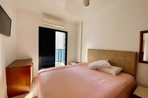 a bedroom with a large bed and a window at SHB - The Jewel Pitangueiras with complete leisure in Guarujá +63 photos