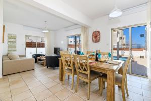 a dining room and living room with a table and chairs at Sunrise Bay Villa #2 in Protaras