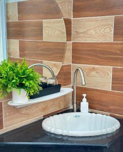 a bathroom with a sink with a faucet at Tiami Eden Villa - Nghỉ Dưỡng Sân Vườn Ven Biển in Vung Tau +50 photos