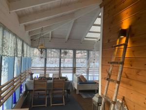 a dining room with a table and chairs in a house at Traditional Lapland 2BR House with Private sauna in Nuupas