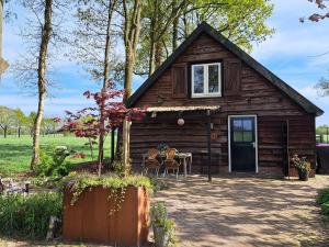 a log cabin with a table in front of it at Vakantiehuis Het Wonder in Siegerswoude