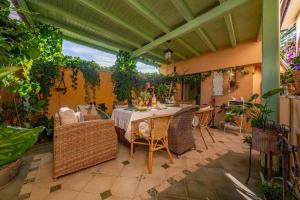 a patio with a table and chairs and plants at Casa Rustica Ivano in Biograd na Moru