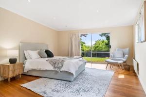 a bedroom with a bed and a large window at Hobart Heritage Home - Close to CBD & Airport in New Town