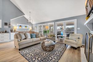 a living room with two couches and a kitchen at Sleeps 24 Waterfront Dock Golf Cart Walk to Beach in Pawleys Island