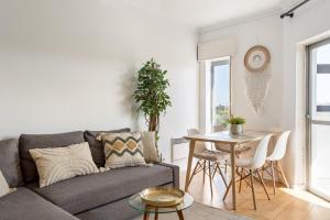 a living room with a couch and a table at Cascais Ocean View by Homing in Cascais