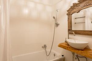 a bathroom with a sink and a shower and a mirror at Cascais Ocean View by Homing in Cascais +13 photos