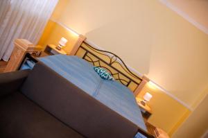 a small bedroom with a bed and a staircase at Pension Villa Maria in Karlovy Vary