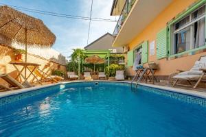 a swimming pool in front of a house at Casa Rustica Ivano in Biograd na Moru
