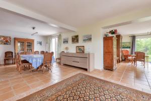 a large living room with a table and chairs at Maison avec jardin pour 10 - 600m plage in Arzon