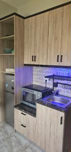 a kitchen with a sink and a microwave at Alora House in Kefalos