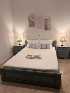a bedroom with a bed with two towels on it at Thalassa house by the sea in Áyios Yeóryios