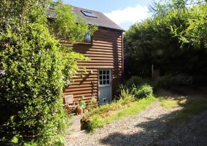 a wooden house with a door in a yard at Eco-friendly Cornish sanctuary in Penzance