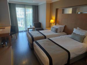 A bed or beds in a room at Ramada Resort by Wyndham Bodrum