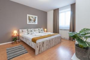 a bedroom with a large bed and a potted plant at Villa Lavanda near Pazin, a modern pool villa in the heart of Istria in Pulići +32 photos