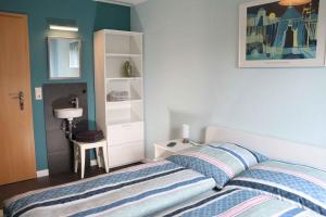 a bedroom with a bed and a white cabinet at Ferienwohnung Voege in Schmallenberg
