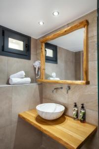 a bathroom with a sink and a mirror at Theros Easy Living in Theologos