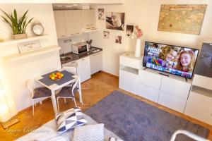 a small living room with a small table and a kitchen at New Old Town Square Sdudio in Prague +7 photos