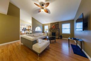 a living room with a couch and a ceiling fan at Cozy Retreat 3bdrm 2bath house with deck in Columbia