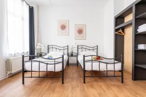 a room with two beds and two chairs at Hotel Abberdeen in Brussels