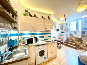una cucina con lavello e lavatrice di Film Poster or Coffee Basement Apartman with terrace a Budapest