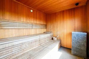 a wooden sauna with a bench in a wooden wall at Seaside Garden by Baltic Home Świnoujście in Świnoujście