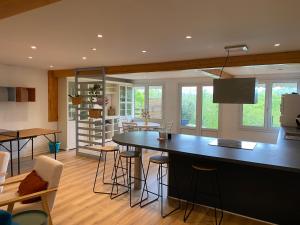 a kitchen with a large black island in a room at Villa émeraude in Cublac