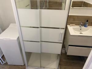 a bathroom with a sink and a white cabinet at Casa Padulella (4 appartements) in Moriani Plage +32 photos