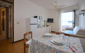 a living room with a table with plates on it at Appartamenti La Quercia in Bibione