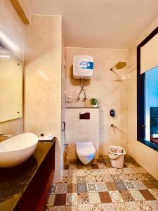 a bathroom with a sink and a toilet at Apurwa Grand Resort in Baragrān +34 photos