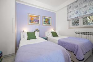 Ένα ή περισσότερα κρεβάτια σε δωμάτιο στο Villa Principi apartment Violet +20 φωτογραφίες