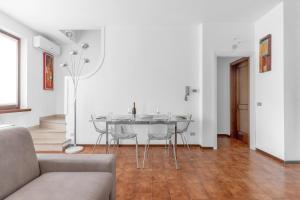 a living room with a table and a couch at Villa Imperiale - Private Pool & Relax in Desenzano del Garda