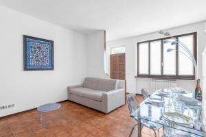 a living room with a glass table and a couch at Villa Imperiale - Private Pool & Relax in Desenzano del Garda