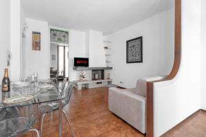 a living room with a glass table and a couch at Villa Imperiale - Private Pool & Relax in Desenzano del Garda