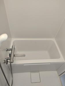 a white sink in a bathroom with a faucet at はなおか in Takayama +9 photos