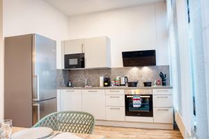 a kitchen with white cabinets and a stove at Urban Suite in Amberg