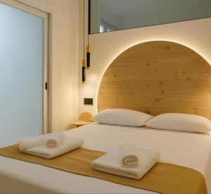 a bedroom with a bed with two towels on it at ZELUN Suite Torremolinos Center in Torremolinos