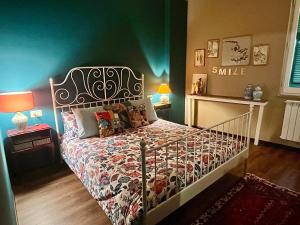 a bedroom with a bed with a white bed frame at LA MAGIA nel BORGO in Fezzano