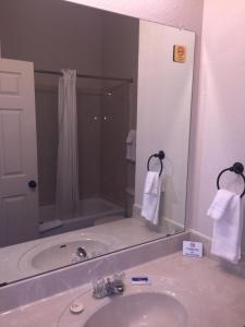 a bathroom with a sink and a large mirror at Studio 7 Harker Heights in Harker Heights