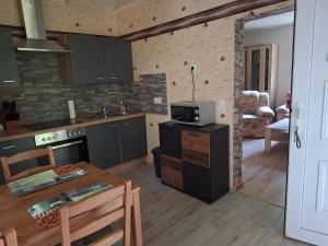 a kitchen with a stove and a microwave on a counter at Ferienhaus Hochwald in Wadern