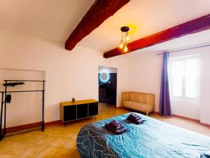 a bedroom with a bed in a room at Entre montagne et lavande - Maison Provençale in Saint-Étienne-les-Orgues