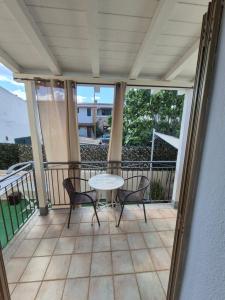 a patio with a table and chairs on a balcony at Affittacamere D&D in Porto San Paolo +6 photos
