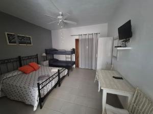 a bedroom with a bed and a table and a television at Affittacamere D&D in Porto San Paolo