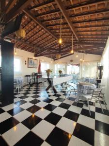 a room with a checkered floor and a table and chairs at Pousada Tiriri Guesthouse in Barra do Camaragibe +36 photos