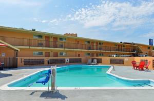 a swimming pool in front of a hotel at Americas Best Value Inn Ponca City in Ponca City
