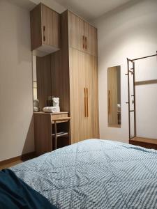 a bedroom with a bed and a desk and a mirror at Umi SplashMania homestay in Banting +23 photos