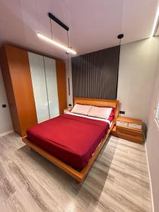a bedroom with a large red bed in a room at Villa Mont-roigh in Tarragona
