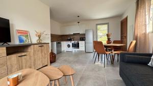a kitchen and living room with a couch and a table at Appartement Casa Solea in Barrettali