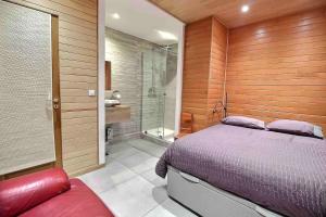 a bedroom with a bed and a walk in shower at Spacious Duplex Pantin, near Paris in Pantin