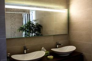 a bathroom with two sinks and a mirror at Spacious Duplex Pantin, near Paris in Pantin